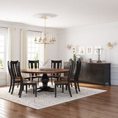 a dinning room table with chairs and a rug in front of the window is shown