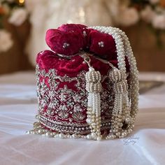 Indulge in timeless elegance with our exquisite bridal potli bag, meticulously crafted in deep red velvet to capture the essence of luxury and tradition. Designed with South Indian brides in mind, this opulent accessory is adorned with intricate dabka, beadwork, sparkling stones, and shimmering sequins, ensuring a mesmerizing entrance on your special day. Elevate your bridal ensemble with this stunning potli bag, a symbol of sophistication and grace. Product Details: *Handmade with traditional Pakistani and Indian techniques *Spacious interior  *Measures 6 inches To explore additional styles, kindly visit our website at dulhansdiary.etsy.com. . . . . . . #silverpotlibag #handmadeclutch #bridalhandbag #weddingaccessories #ethnicbag #uniquegift #artisanmadeclutch #punjabiclutches #potlibag # Hand Bag For Bride, Bridal Bag For Wedding Day Indian, Bride Purse Wedding Day, Red Shoulder Bag For Festive Gift, Festive Red Shoulder Bag As Gift, Festive Red Shoulder Bag For Gifts, Red Embroidered Shoulder Bag For Wedding, Luxury Red Formal Pouch, Red Shoulder Bag For Festivals As Gift