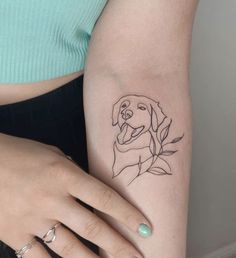 a woman's arm with a dog tattoo on the left side of her body