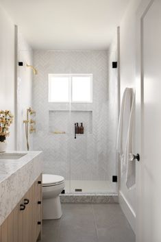 a bathroom with a toilet, sink and shower