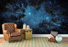 a living room with a chair, lamp and stars in the night sky wall mural