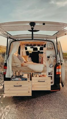 an image of the back end of a van with its doors open and furniture in it