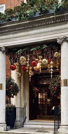 an entrance to a building decorated with christmas decorations