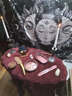 a table topped with lots of items on top of a wooden floor next to a wall