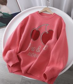 This playful pink oversized sweater is perfect for adding a fun and cozy touch to your wardrobe. The front features a charming cherry graphic, adding a whimsical vibe to the overall design. The text below the graphic reads “Sweet & Cute,” making this sweater a cheerful and stylish choice for casual days. The soft pink hue adds a pop of color to any outfit, while the relaxed fit ensures maximum comfort.Made from high-quality knit fabric, this sweater offers warmth and coziness without compromisin Oversized Trendy Sweater, Oversized Knit Tops With Letter Print, Knit Long Sleeve Sweater With Letter Print, Knit Sweater With Letter Print And Long Sleeves, Cute Oversized Letter Print Sweater, Oversized Cute Sweater With Letter Print, Red Trendy Sweater With Graphic Print, Trendy Pink Sweatshirt With Ribbed Cuffs, Trendy Red Sweater With Graphic Print