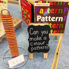 children's books and toys on display in a classroom with signs that read can you make a color pattern?