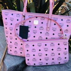 MCM medium zip shopper tote bag purse pink Brand new with tag. Dust bag. Care card.  Anya Medium pink zip shopper tote bag. Wristlet Is detachable. Baby pink color.  It’s about 14.5L (base) 17.5 (opening7 X 6W X 11”H Pouch is about 10.5” X 6”H X .5 Handle drop is 9.25” MCM Bags Totes Large Pink Shoulder Bag For Shopping, Pink Double Handle Shoulder Bag For Shopping, Hot Pink Mcm Bag, Pink Mcm Tote Bag, Mcm Purse, Luxury Tote Bags, Pink Tote Shoulder Bag With Silver-tone Hardware, Expensive Bag, Aesthetic Bags