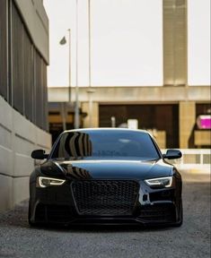 a black car parked in front of a building