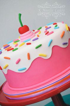 a birthday cake with sprinkles and a cherry on top