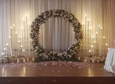 a decorated stage with candles and flowers on it