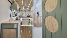 an interior view of a tiny home with wood flooring and white walls, along with green trim