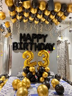 a birthday party with balloons and streamers in the shape of number twenty three,