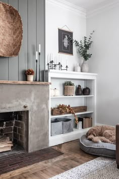 a living room filled with furniture and a fire place next to a wall mounted fireplace