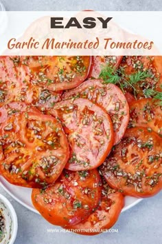 a white plate topped with sliced tomatoes and herbs