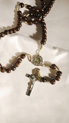 Handmade Rosary: *Artisanally crafted with utmost care and intention *Made with high-quality 10mm wooden beads *Designed to encourage mindfulness and spiritual connection *Color: brown *Heart metal medal with colored enamel Jesus Crucified image Blessed and Durable: *Each piece is imbued with a special blessing intention *Handcrafted with love for a lasting keepsake *Lightweight and delicate, perfect for daily use or as a gift for a loved one Purpose-Driven: *Created to be a tool for devotion and intimacy with God *Helps deepen your spiritual journey and find solace in faith *Aims to bring peace and comfort to your daily life Handmade Brown Rosary For Healing, Adjustable Brown Spiritual Rosary, Spiritual Brown Rosary For Healing, Handmade Brown Spiritual Rosary, Beaded Brown Rosary Gift, Adjustable Brown Wooden Beads Rosary, Brown Beaded Rosary As Gift, Brown Beaded Rosary Gift, Adjustable Brown Wooden Bead Rosary