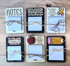 four magnets tied up to each other with some writing on them and an apple