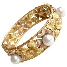 BUCCELLATI Bracelet in Three Golds : yellow Gold, white Gold, pink Gold with Leaf Motifs with 6 gray Pearls of about 1 cm Diameter. Bracelet Adorned with chased and yellow Gold Flowers, alternated with Amati chiseled grey Gold Flowers punctuated with cultured Pearls, edged with chiseled rose Gold Stem. Rigid Opening Bracelet with Eight Security. The Bracelet is signed Buccellati. Gross weight: 61.1 g Length : 18 cm Diameter: 56 x 63 mm (oval) Width: 2cm This splendid bracelet is in very good con Buccellati Bracelet, Gold Beaded Headband, Buccellati Jewelry, Vintage Gold Bracelet, Diamond Cuff Bracelet, Modern Bracelets, Yellow Gold Bangle, Antique Bracelets, White Gold Sapphire