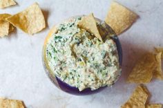 a tortilla shell filled with dip and chips