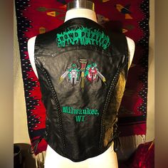 Bikers Unite!! This Is One Of The Quirkiest/Coolest/ “One Of A Kind” Leather Biker Vests!! “Crowd Pleasers Milwaukee, Wi -Queen B/Treasurer” Like New Vintage Condition (No Flaws And Appears Unworn, Leather & Embroidery Well-Preserved) Bust 36” With Adjustable Leather Side Ties (See Pics) Length 22” Thanks For Stopping By Leather Biker Vest, Leather Embroidery, Biker Vest, Milwaukee Wi, Queen B, New Vintage, Vintage Leather, Black Green, Milwaukee