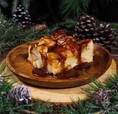 a piece of bread covered in caramel sauce on a wooden plate