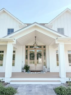 a white house with front porch and entryway