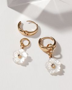 Are you ready to take your summer vacay style to the next level? With its gorgeous golden plating, this piece is crafted to accent and flatter all skin tones. Day or Night, show off its beautiful charm - featuring genuine carved mother of pearl shell and CZ center - or easily remove it for a basic hoop to wear while hiking and exploring. Not only that, but this earring looks like a piece usually found in fine jewelry stores. Chic Summer Jewelry With Flower Charm, Trendy Gold Hoop Earrings With Flower Charm, White Shell-shaped Hoop Earrings, Gold Shell-shaped Hoop Earrings For Pierced Ears, Elegant Shell-shaped Gold Plated Earrings, Gold Shell-shaped Hoop Earrings, Luxury Flower-shaped Mother Of Pearl Earrings, Night Show, Capricorn And Aquarius