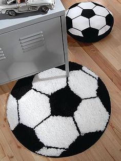 a black and white soccer ball rug next to a metal cabinet