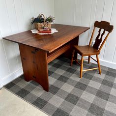 a wooden table with two chairs next to it and a potted plant on top