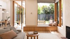 a living room filled with furniture and a fire place in front of a sliding glass door