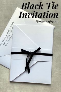 an open envelope with a black ribbon tied around it and the words, black tie innovation