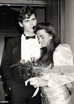 a young man and woman standing next to each other wearing tuxedos, bow ties