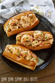 three pieces of bread on a plate with shrimp in it and garnished with scallops