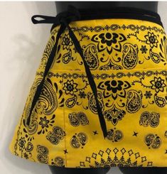 a woman's yellow skirt with black and white designs