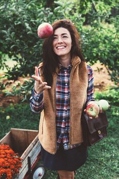 a woman is throwing an apple into the air