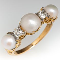 This antique ring features three (3) prong set, natural pearls. The pearls are accented with a total of two (2) prong set, round old European cut diamonds. The faces are accented with a filigree design. The ring measures 7.3mm at the top, rises 5.7mm above the finger, tapering to 1.6mm wide and 0.9mm thick at the base of the shank. The ring is currently size 7.25. Luxury Antique Pearl Ring With Diamond, Classic Three Stone Pearl Ring, Natural Buttons, Pearl And Diamond Ring, Engagement Ring Shapes, Pearl Diamond, European Cut Diamonds, Pretty Rings, Brilliant Diamond