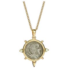 This DUBINI coin necklace from the 'Empires' collection features an authentic Roman denarius silver coin dating circa 74 B.C. set in 18K yellow gold with peridot and citrine cabochons. Coin Ø 17-19mm Chain Length: 47cm Depicted on the coin: Obverse - Bust of Diana right, wearing hair tied into knot; bow and quiver over shoulder. Reverse - Hound running right; hunting spear below. HISTORY Diana was the Roman goddess of hunting, nature, childbirth, and later the moon. In Roman art, she often appea Ancient Yellow Gold Coin Pendant Jewelry, Ancient Yellow Gold Medallion Necklace, Ancient Style Coin Pendant Medallion Necklace, Ancient Style Coin Pendant Necklace, Ancient Style Yellow Gold Medallion Necklace, Ancient Style Medallion Necklace In Yellow Gold, Yellow Gold Amulet Coin Necklace, Yellow Gold Coin Pendant Necklace In Amulet Style, Byzantine Style Medallion Coin Necklace