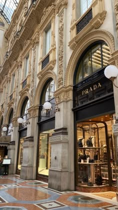 an ornate building with many windows and lights on the side walk in front of it