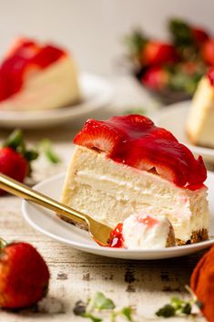 a slice of cheesecake with strawberries on the side