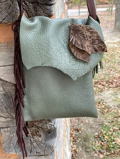 This listing is for an olive deerskin purse with dark chocolate fringe.  Beautiful colors together.  Inside there is a pocket for credit cards so that you can travel really light if you dont want to carry a wallet.  There are hair on hide leather feathers on the front and fringe on the back as well.  The pocket of this purse is 10" deep X 8" wide.  If you have any questions please let me know.  To view more purses and handbags you can follow this link  https://www.etsy.com/shop/HollyHawkDesigns?ref=seller-platform-mcnav&section_id=18938232 Leather Feathers, Boho Leather Bags, Leather Fringe Bag, Western Purses, Look Rock, Fringe Bags, Boho Bags, Handbag Patterns, Handmade Purses