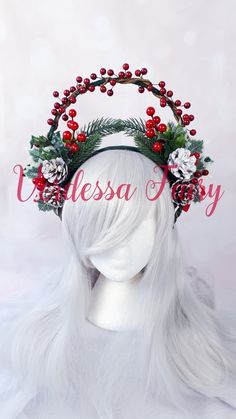 a white wig wearing a christmas wreath and holly berry headband with red berries on it