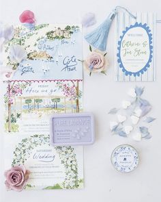 the wedding stationery is laid out with flowers and other things to put on it