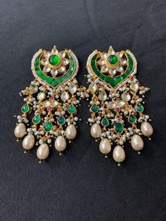 *It's Handmade Indian Ethnic Kundan Earrings with Green color combination. *It's made from Silver n Copper with Green N Pink Stones Settings and Beaded with Pearls with 22k gold Plating as shown in picture. *It is Pure Ethnic Look with Antique Touch and 2.7 inches Long. *Our all jewelry is made from semiprecious stones and beads. *WARRANTY: ITS GENUINE HANDMADE JEWELRY AND WE ARE GIVING LONG LIFE WARRANTY FOR OUR ALL ITEMS. All of our Kundan Jewelry is 100% handmade with ancient Kundan stone set Earring Indian, Stud Earrings Unique, Indian Gifts, Polki Earrings, Bridal Jewelry Collection, Bridal Hair Jewelry, Potli Bags, Polki Jewellery, Pakistani Jewelry