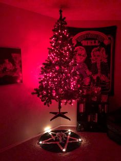 a christmas tree with pink lights in a room