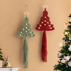 two christmas trees are hanging on the wall