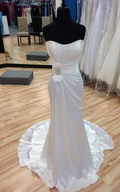 a white wedding dress on display in a store