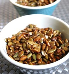 two bowls filled with nuts on top of a table