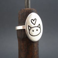 This is so simple and so cute! I hand make this ring in my Oakland studio. The top of the ring measures 3/4 of an inch tall and the entire ring is solid sterling silver. If the whole sizes in the drop down menu don't match your size send us your ring size in notes to seller at checkout. All rings are made to order and take about a week before we send them out. To see the matching necklace go here: https://www.etsy.com/listing/198777553/love-me-love-my-cat-necklace-sterling?ref=shop_home_active_7 Adjustable Sterling Silver Cat Design Rings, Handmade Cute Sterling Silver Rings, Cute Handmade Sterling Silver Rings, Silver Cat Ring, Sterling Silver Cat, Cat Ring, Silver Cat, Cat Necklace, Matching Necklaces