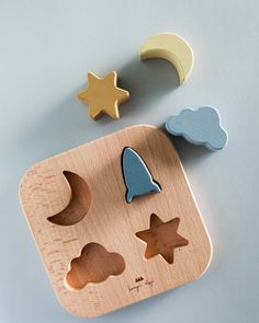 a wooden toy with shapes and stars on it