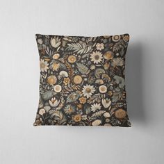 a black and brown pillow with flowers on it