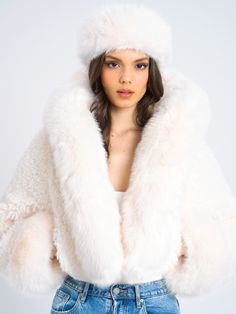 Elevate your style with our high quality Kali Cropped Vegan Fur Jacket, a lavish and chic wardrobe essential. Crafted from luxe vegan fur, this cropped jacket boasts a soft feel and features an attached hood adorned with a puffy fur trim. Fully lined for comfort, Kali adds a touch of glamour to any special occasion or everyday ensemble. This jacket promises to turn heads when you walk in the door. Why buy real fur when our faux feels the same! Materials:Vegan Fur: 100%Polyester Stretch Factor: N Winter White Faux Fur Coat, Luxury Faux Fur Coat For Cold Weather, Winter White Faux Fur Coat For Cold Weather, Luxury Faux Fur Outerwear With Feather Trim, Luxury Faux Fur Outerwear With Fur Trim, Luxury Faux Fur Winter White Outerwear, Luxury Hooded Faux Fur Outerwear, Luxury Outerwear With Faux Fur Trim, Winter White Faux Fur Outerwear With Lining